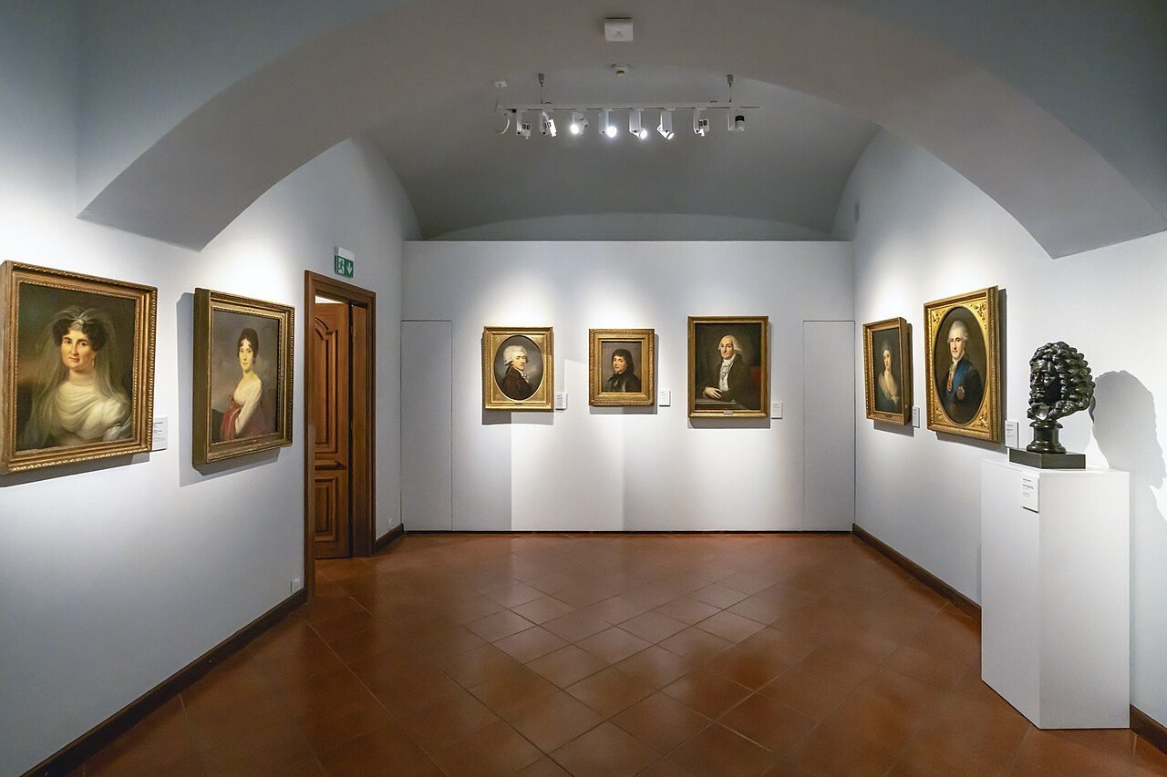Bright gallery interior with paintings on the walls